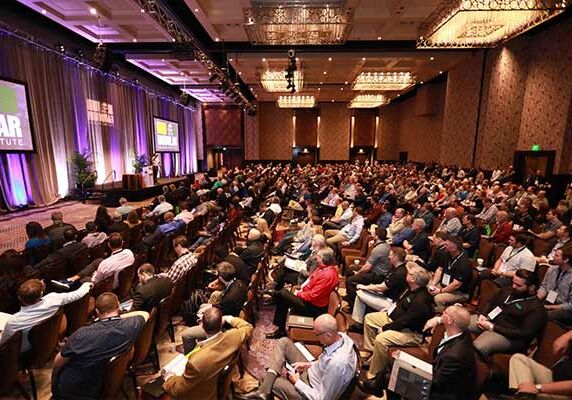 A conference room of modular construction innovators and company owners learning more about the industry