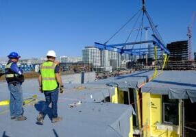 A set crew places part of a volumetric modular building