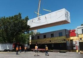 crane lowering modular building into place